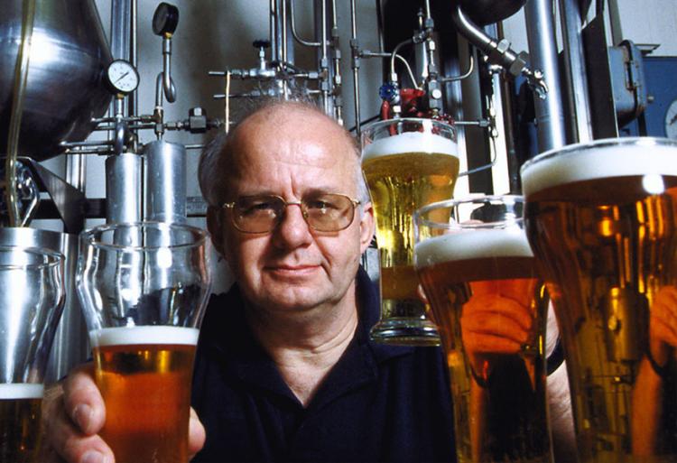 UC Davis brewing professor Charlie Bamforth surrounded by glasses of beer.