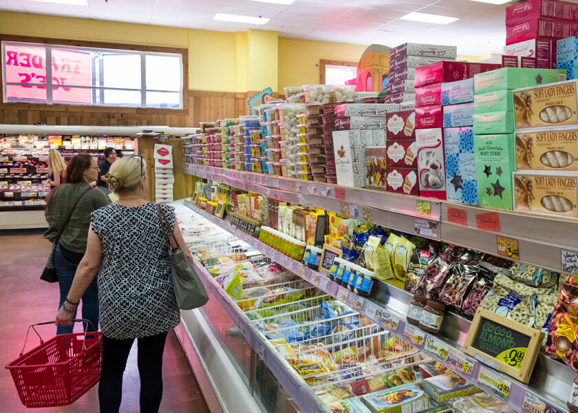 Photo shows shoppers inside the freezer aisle at Trader Joe’s market. 