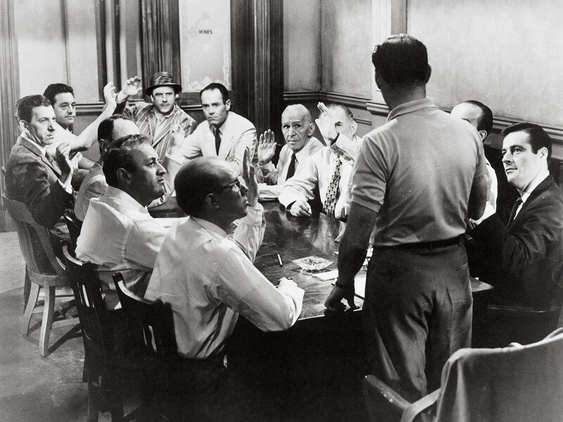 A screenshot from the classic 1957 courtroom movie, 12 Angry Men. Juries are a prime example of democratic deliberation in action. Governments and researchers would like to expand the approach to broader settings.