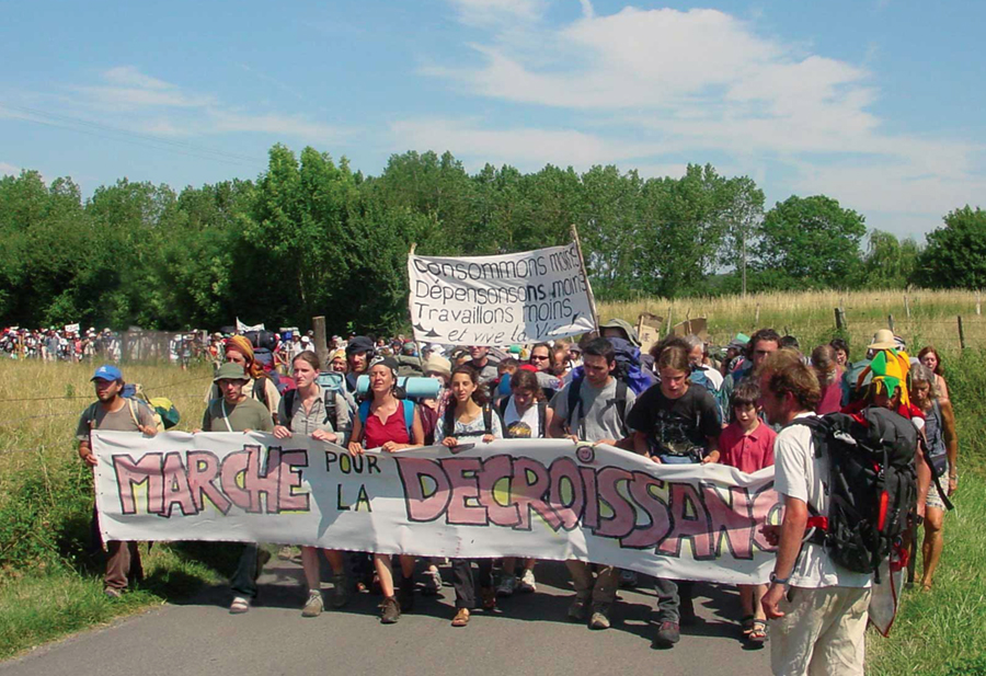 Photo shows the Inaugural March for Décroissance, 2005, ‎Magny-Cours, France. More than 70 protesters marched between Lyon and Nevers, France, the majority of them youth. They demanded suspension of the French Grand Prix, Formula 1 race, a humiliating symbol of wasteful excess. José Bové, Albert Jacquard, Serge Latouche and François Schneider gave speeches in the village of Mangy-Cours.