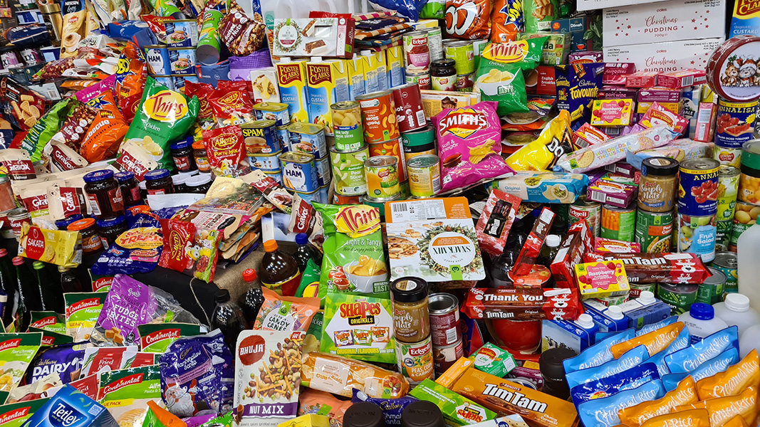 Photograph of a huge array of processed foods in colorful packages, including lots of chips and crackers.