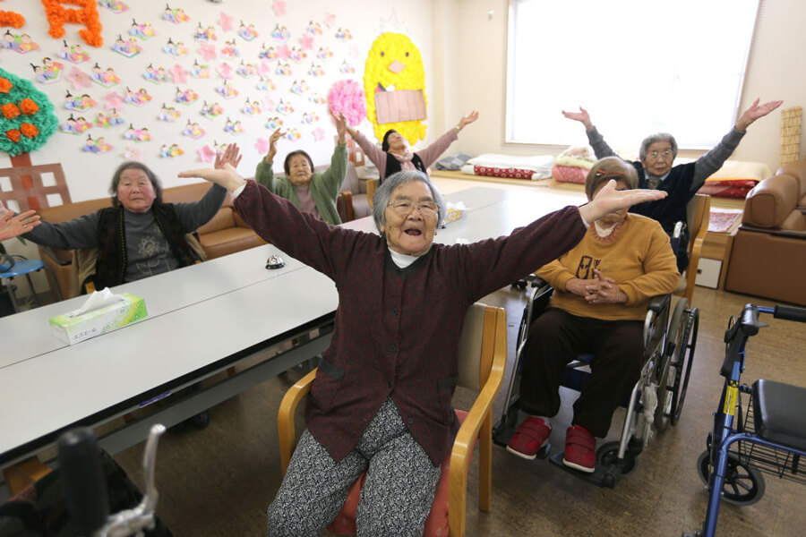 Elderly Japanese women exercising together.