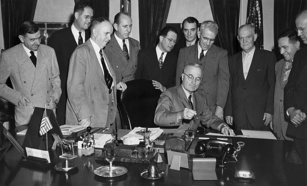 Photo shows President Harry Truman signing the National School Lunch Act on June 4, 1946.