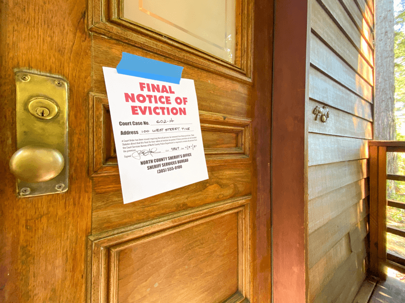 Photo of eviction notice posted on the door of a house.