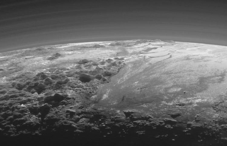 New Horizons’ image of Pluto’s horizon just after the spacecraft’s closest approach to the dwarf planet. Icy mountains and flat ice plains are visible. Backlit and taken near sunset, the image reveals many layers of haze in Pluto’s thin atmosphere.