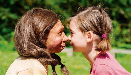 Image shows Neanderthal and human child, face to face.