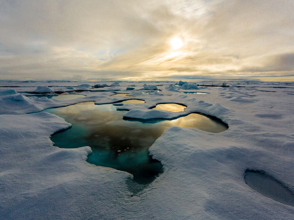 Melt ponds form on the surface of the ice cover in the Arctic sea